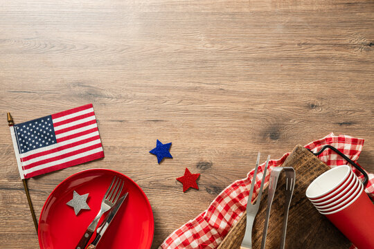 Independence day table setting with American flag plate and copy space top view