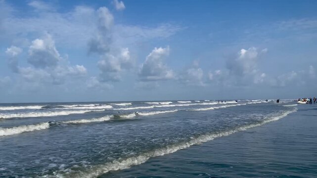 Lots of people on the beach during the summer season. The popular sandy Cleopatra Beach in Cox's Bazar. Silhouettes of people on the background of the sea, beach, Summer season.