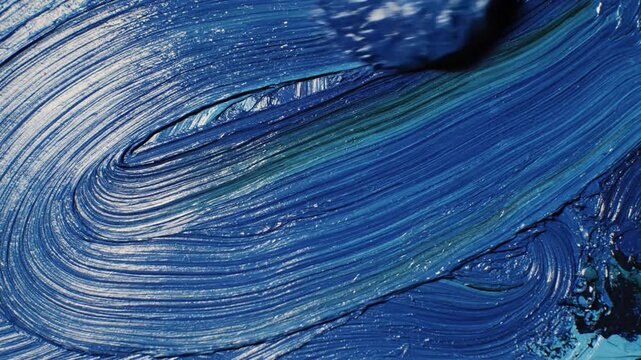 Thick blue oil paint texture with expressive brushstrokes and impasto