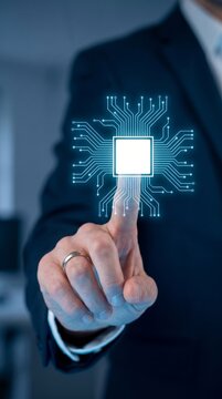 A businessman points his finger at a glowing digital microchip circuit representing future innovation and advanced modern computing systems