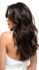 Fototapeta premium With soft waves flowing down her back, the model highlights her dark brown hair beautifully. The styling accentuates her features while evoking a sense of elegance and charm