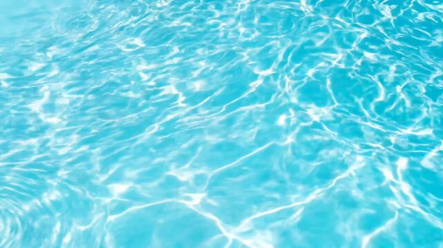 Sunlit turquoise swimming pool water texture with shimmering ripple reflections for abstract summer background.