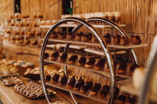 The image shows a buffet table with neatly arranged canap&eacute;s arranged on a tiered stand. 