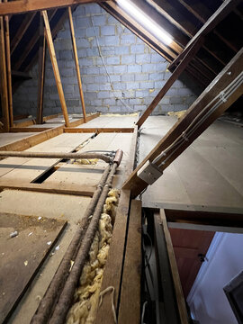 UK loft interior with pitched roof timbers and boarded floor