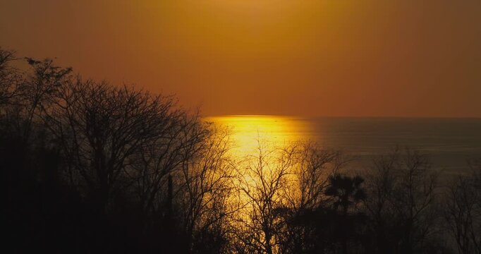 Golden sunset over tropical islands and ocean in Labuan Bajo