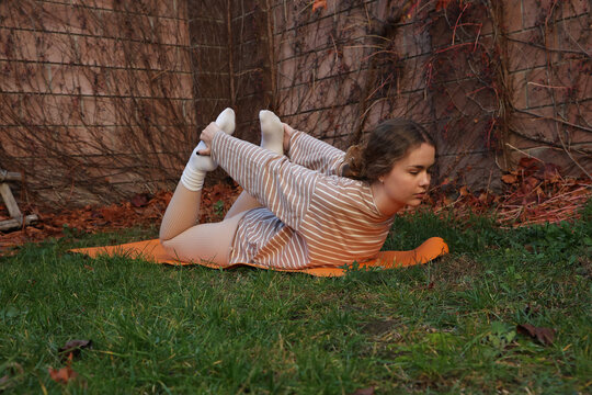 A beautiful young girl is doing sports 
