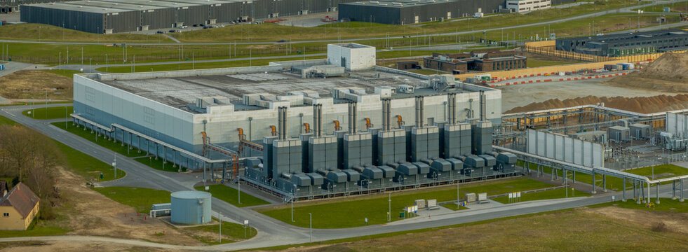 Large-scale data center facility with cooling units, robust power system, and interconnected pipelines that ensure optimal server performance. Digital storage and scalable cloud computing environment.