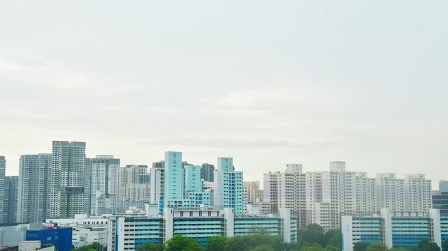 Panoramic zoom in view Skyline of residential high-rise buildings in Singapore. Blue and white HDB flats and modern apartments showcase urban density and planning in the heartlands