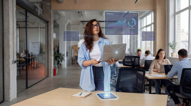 Data analyst woman reviewing digital charts on laptop in modern office