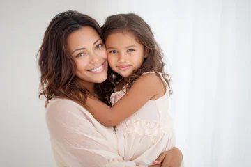 Fototapete Tierärzte Tender mother and daughter embrace on a pristine white backdrop  © Alona