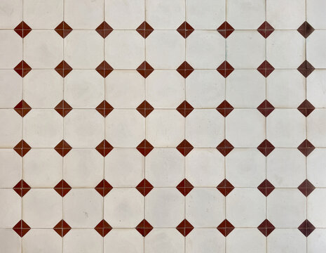 Colonial heritage tiles in random classic geometric shape, diamond patterns. Handmade colonial tiles old heritage tiles in red, white, and beige tiles. Seamless background texture.