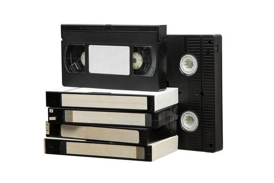 Stack of old VHS video cassette tapes isolated on a white back