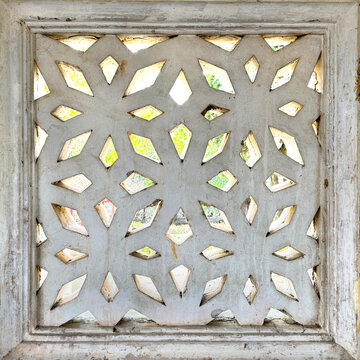 Close up pattern of molded clay or ceramic latticework, or Roster, in flower pattern. Latticework is a molded or cutout pattern made of clay and ceramic. Finished in white color. Breeze blocks