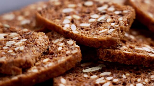 Crunchy dark rye bread rusks with sunflower and flax seeds. Gourmet artisanal croutons. Rotation