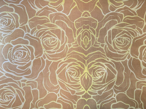 Close up of rose flower shape in metallic gold and rustic bronze color. Elegant floral shape pattern carved on a panel. For wall, floor, or graphic illustration. Seamless background texture.