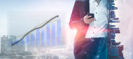 A businessman stands in an urban environment, using his smartphone while financial graphs illustrate growth and analytics, blending modern technology with corporate themes. Impute © InfiniteFlow