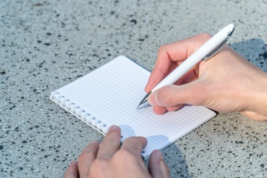 Person Writing in Notebook for Business Strategy and Creative Planning