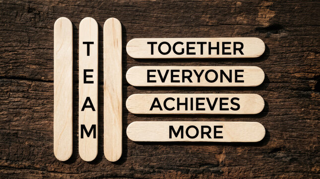 TEAM acronym on wooden sticks, Together Everyone Achieves More motivational concept, business teamwork and collaboration message on rustic wood background