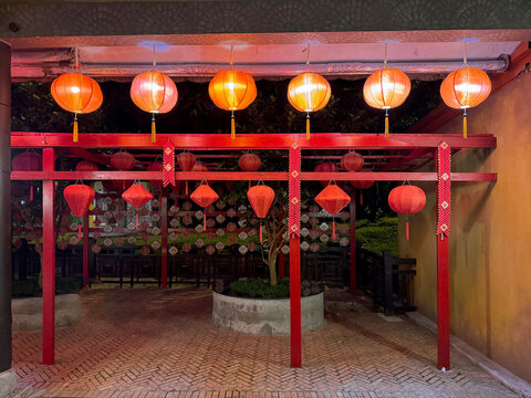 Typical Vietnamese red lanterns hanging and displayed along the alley structural beam. These lanterns are influenced by Chinese culture hence the resemblance. Culture and travel photo.
