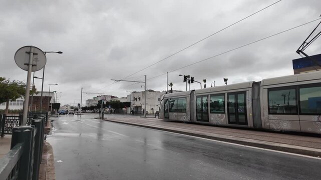 Rabat city tram moving through busy intersection with modern buildings, Morocco &ndash; February 8, 2026
