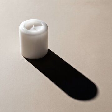 Trendy high contrast hard shadow single minimal wax candle