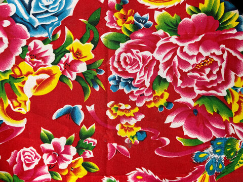 Close up of Chinese theme floral art graphic illustration printed on wallpaper or fabric. In red, green, gold, and yellow color. Oriental east asian dragon and flower pattern. Seamless background