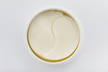 Jar with eye patches isolated on white background. Eye pad cosmetic product. Top view.  © alexburakov12