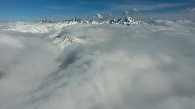 Camera flying toward Kackar Mountains rising above clouds in the Black Sea region of Turkey. Dramatic sky and mist reveal Pontic Alps scenery in Northern Anatolia landscape.