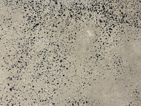 Close up of grey terrazzo granite tiles with colorful black small gravels texture. Terrazzo is increasingly being used in contemporary edgy and stylish interior as wall or floor finishing.