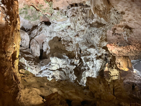 Magnificent cave walls and ceiling texture displaying stalactites and stalagmites with karst and natural limestone rock formations carved by nature.