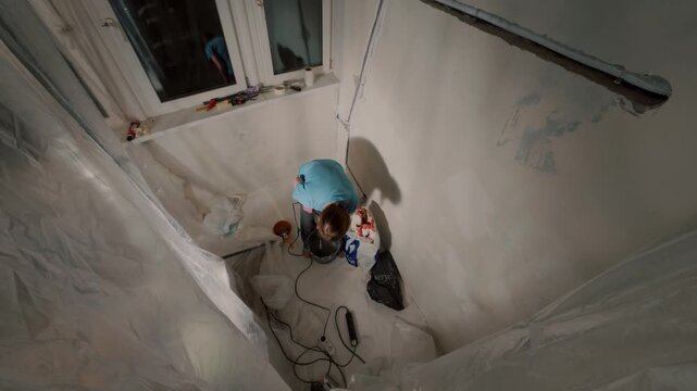 Woman doing home renovation alone in apartment