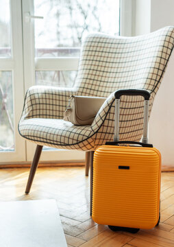 Yellow suitcase and handbag preparing for travel journey