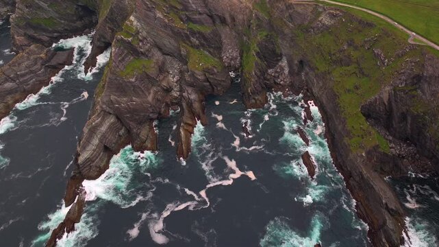 Kerry Cliffs at Cloudy weather Aerial Shot. Dramatic Rocks on the West Ocean Coast in Kerry County, Portmagee, Ireland
