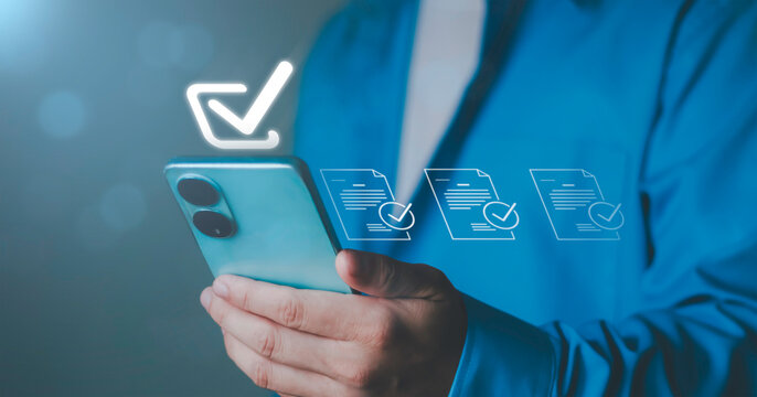 checkmark for digital approval and task completion. online procurement documents, contract warranties and licenses on mobile procurement devices for businesses and startups