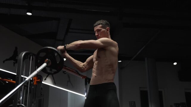 Bodybuilder in sport gym do landmine exercise. Sport bodybuilder with barbell landmine. Barbell landmine. Fitness and bodybuilding. Landmine shoulder to shoulder press. Shoulder exercise
