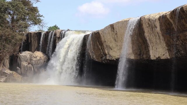 Natural Dry Nur waterfall background video with copy space for design and branding. Vietnam