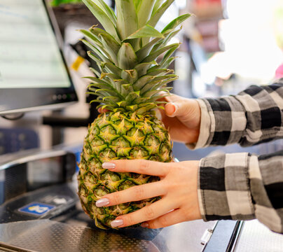 Girl Using Self-Checkout At Supermarket