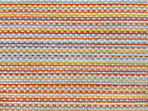 Close up of colorful woven fabric in horizontal stripes pattern. Mix vibrant colors of red, yellow, orange, blue, and grey.  Cheerful vibes. For upholstery, wallpaper, and graphic background