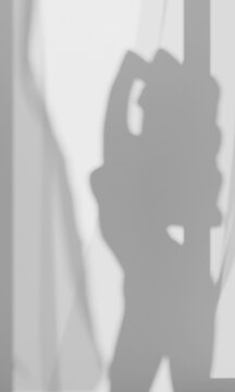 womans shadow posing by a window
