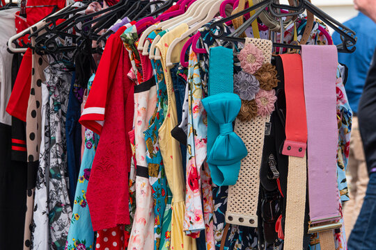 Clothes and belts for sale at an outdoor market