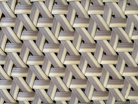 Close up of beautiful hand woven synthetic rattan texture in natural brown and white colors. Wicker art or rattan weaving art pattern in many shapes. Seamless texture.