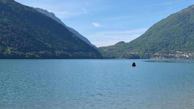 Lone Fishing Boat on Santa Croce Mountain Lake in Tranquil Waters 