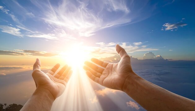 Two hands reaching upward toward a brilliant, sunlit sky filled with clouds and beams of light