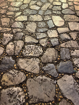 Natural random cut grey flagstone flattened on a surface. Or a series of cobble stones but flattened and paved seamlessly, for floor or wall finishes
