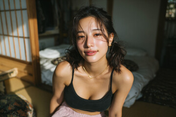 Fototapeta premium serene east asian woman in morning light, young asian woman relaxing in traditional japanese room with soft sunlight, calm portrait of woman with ponytails in airy tatami bedroom