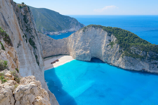 Navagio beach, famous overhead summer lanscape of Zakinthos island, Greece with flowers