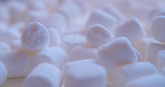 Close-up of many pieces of White Marshmallow. Sweet food. Macro with shallow depth of field.