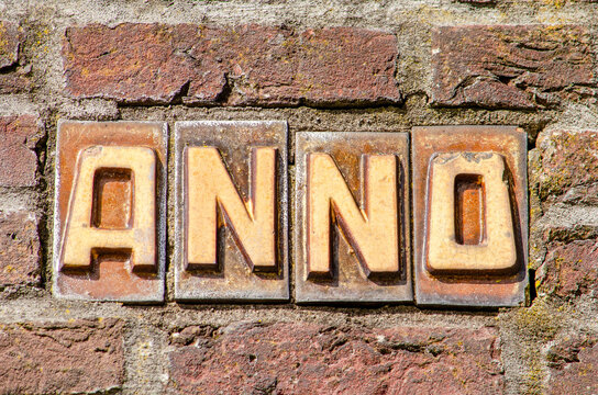 The word "Anno" spelled on a brick wall in the Netherlands
