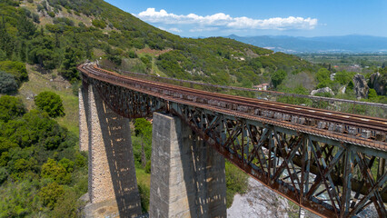 Fototapeta premium High angle view of the historic Gorgopotamos railway viaduct over the river in Greece