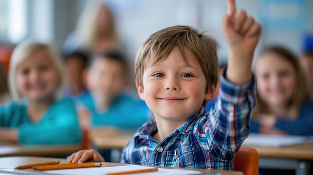 Elementary student eagerly raising hand in classroom discussion